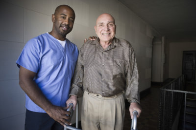 caregiver and senior man in crutches smiling